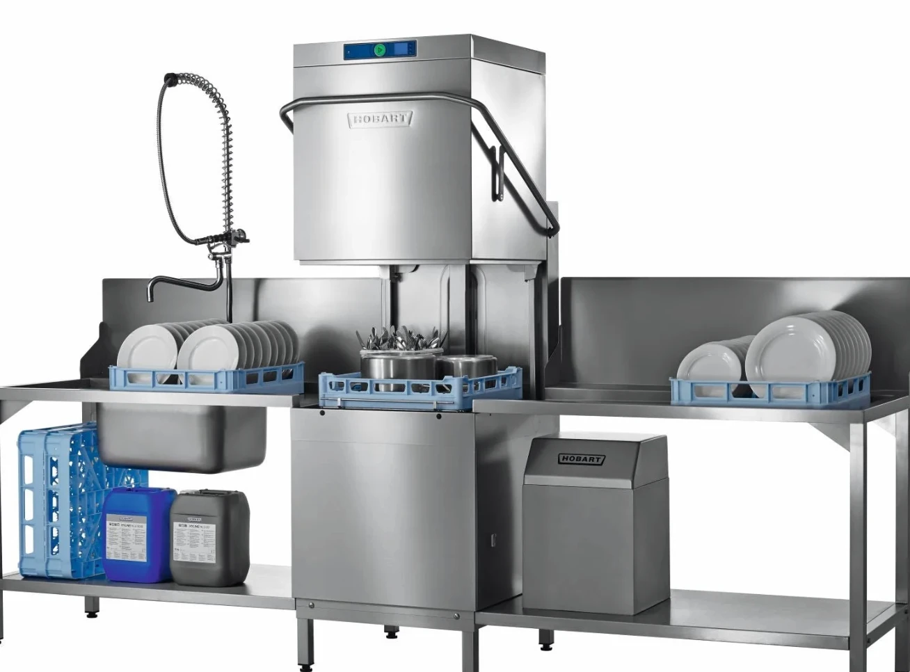 Hood-type commercial dishwasher with racks of plates on stainless steel benches